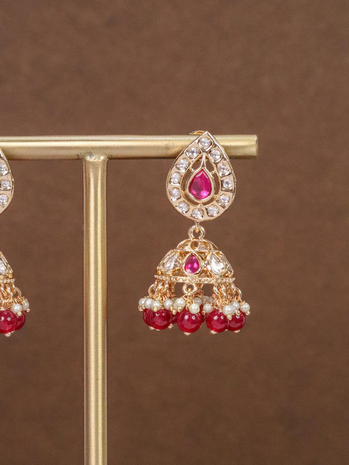 Anika Small Kundan Polki Jhumka Earrings - by Live Some India in just Close Up Image of Anika Small Kundan Polki Red Jhumka Earrings by Live Some India on an earring stand with brown background