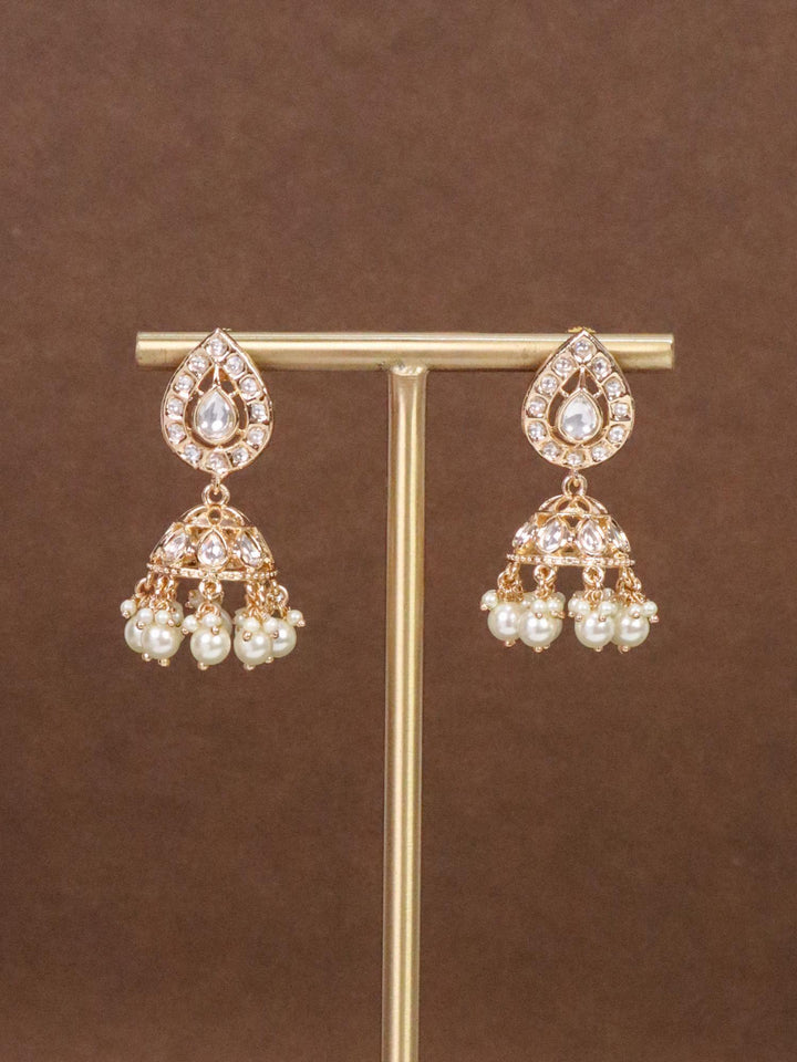 Anika Small Kundan Polki Jhumka Earrings - by Live Some India in just Anika Small Kundan Polki White Jhumka Earrings by Live Some India on an earring stand with brown background