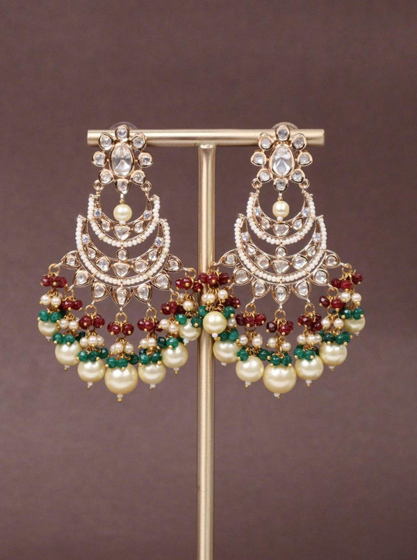 Anvika Kundan Polki Chandbali Dangle Earrings - by Live Some India in just Anvika Kundan Polki Chandbali Earrings - by Live Some India in just A closeup image of Anvika Maroon Kundan Polki Chandbali Earrings - 1 by Live Some India on a brown background