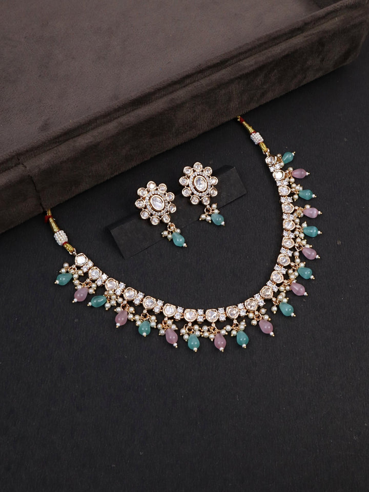 Arya Kundan Polki Necklace Set - by Live Some India in just A closeup image of Arya Pastel Kundan Polki Necklace Set by Live Some India on a brown dummy