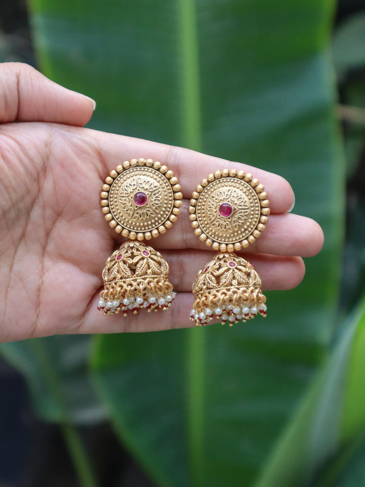 Bhanu Temple Jewellery Jhumka Earrings - by Live Some India in just Bhanu Temple Jewellery Jhumka Earrings by Live Some India on hand with natural green leaves in the background