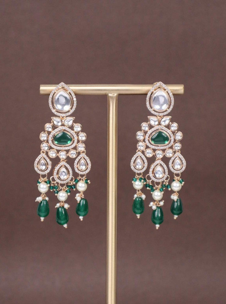 Classy Drops Kundan Polki Dangler Earrings - by Live Some India in just A closeup image of Emerald Drops Kundan Polki Dangler Earrings by Live Some India on a brown background