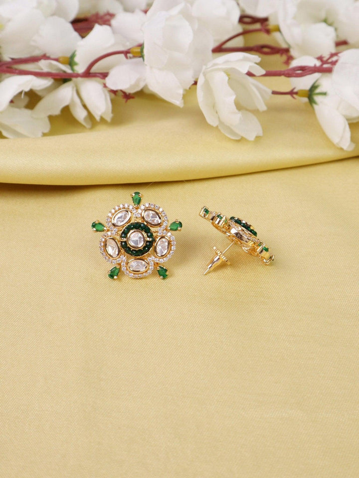 Daksha Kundan Polki Stud Earrings - by Live Some India in just Daksha Kundan Polki Stud Earrings - by Live Some India in just A closeup image of Daksha Kundan Polki Green Stud Earrings -1 by Live Some India on a yellow satin cloth with flowers