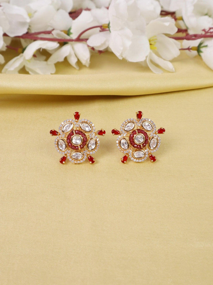 Daksha Kundan Polki Stud Earrings - by Live Some India in just Daksha Kundan Polki Stud Earrings - by Live Some India in just A closeup image of Daksha Kundan Polki Red Stud Earrings by Live Some India on a yellow satin cloth with flowers