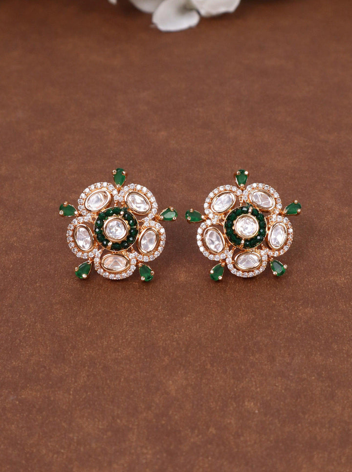 Daksha Kundan Polki Stud Earrings - by Live Some India in just Daksha Kundan Polki Stud Earrings - by Live Some India in just A closeup image fo Daksha Kundan Polki Green Stud Earrings by Live Some India on a yellow satin cloth with flowers