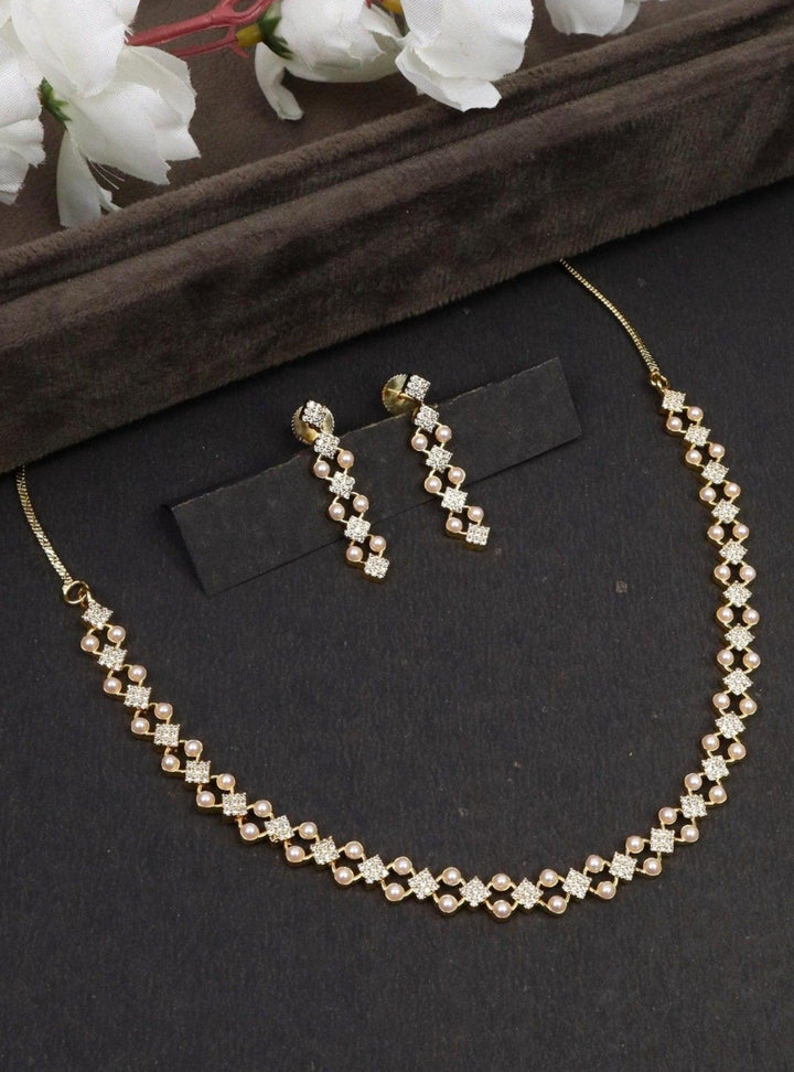 Deepti Pearl Necklace Set - by Live Some India in just A closeup image of Deepti Yellow Pearl Necklace by Live Some India on a black background with brown tray and flowers