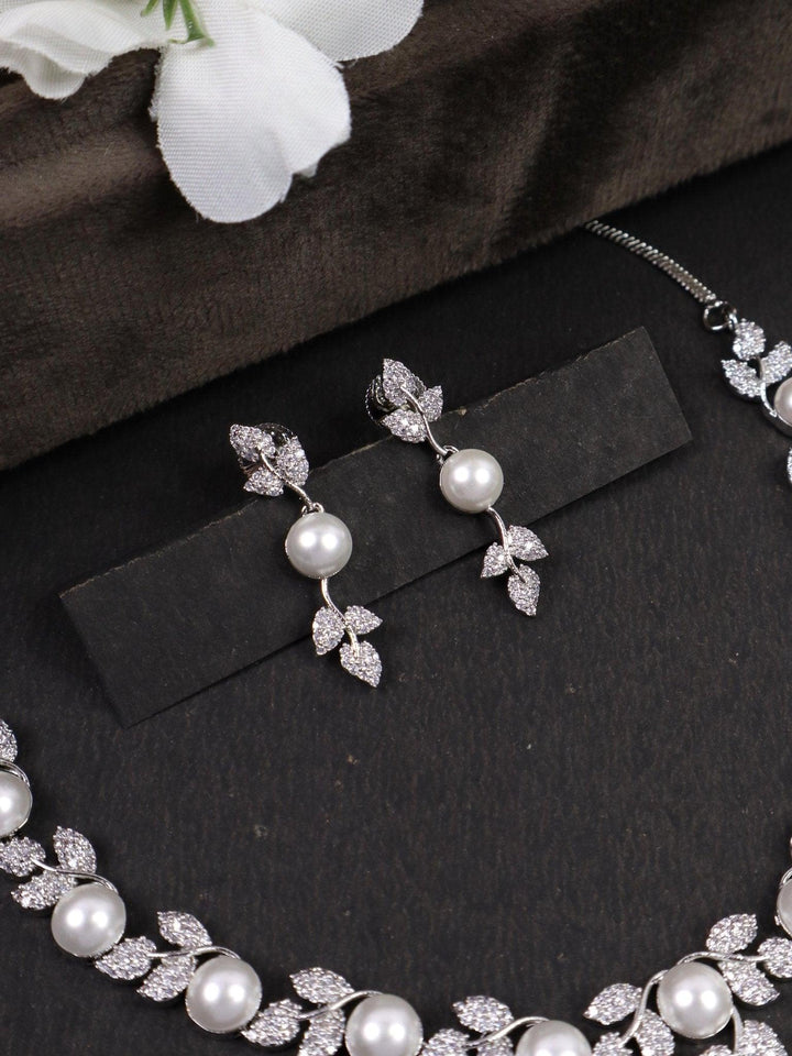 Designer Leaf Pearl Necklace Set - by Live Some India in just Designer Leaf Pearl Necklace Set - by Live Some India in just A closeup image of Designer Silver Leaf Pearl Earrings by Live Some India on a black background