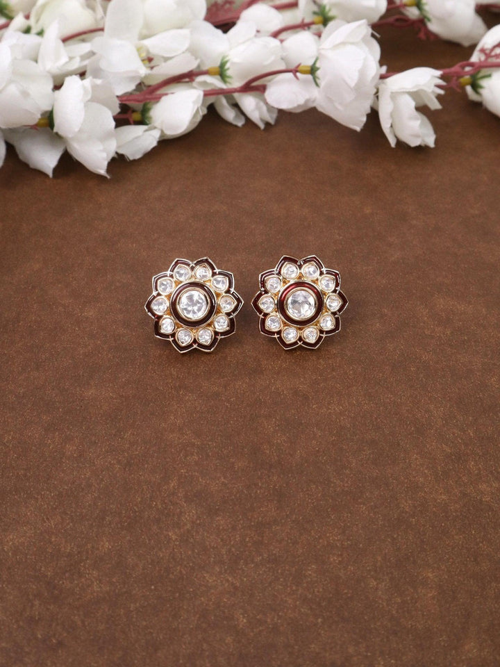 Falak Kundan Polki Stud Earrings - by Live Some India in just A closeup image of Falak Maroon Kundan Polki Stud Earrings by Live Some India on a brown background