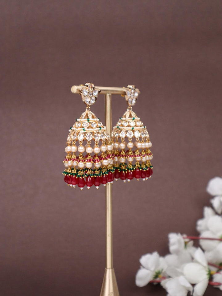 Idah Kundan Polki Jhumka Earrings - by Live Some India in just A closeup image of Idah Red Kundan Polki Jhumka Earrings -2 by Live Some India on an earring stand with a brown background