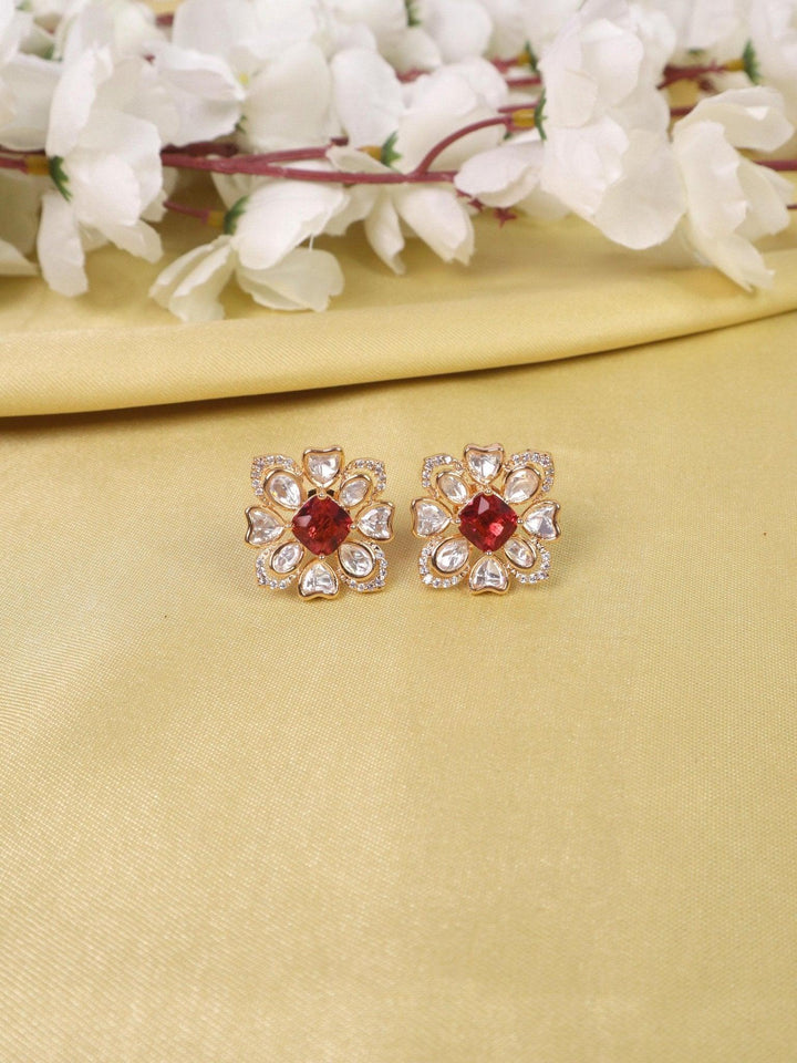 Zoya Kundan Polki Stud Earrings - by Live Some India in just A closeup image of Zoya Kundan Polki Red Stud Earrings by Live Some India on a yellow satin cloth with flowers