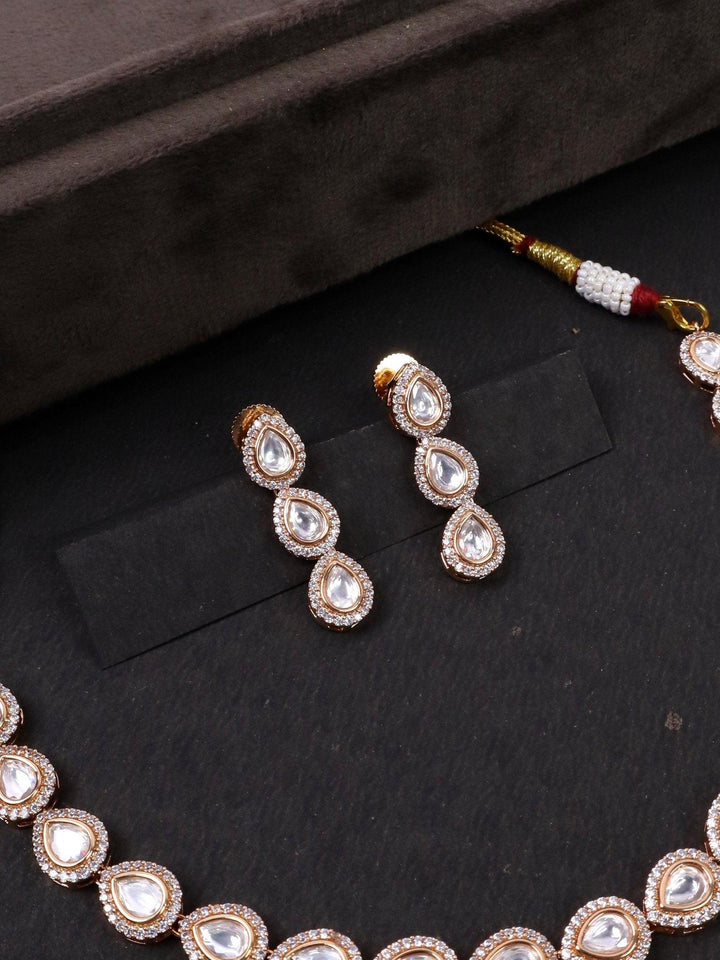 Nira Single Line Kundan Polki Necklace Set - by Live Some India in just A closeup image of Nira Kundan Polki Earrings by Live Some India on a black background