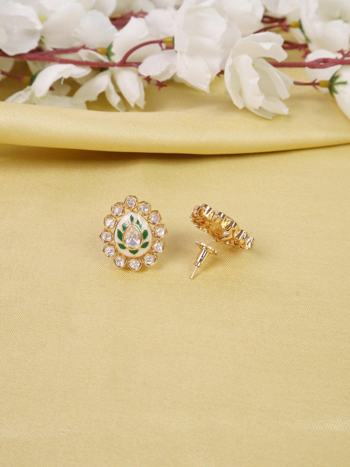 Uryam Kundan Polki Stud Earrings - by Live Some India in just A closeup image of Uryam Kundan Polki Green Stud Earrings -1 by Live Some India on a yellow satin cloth with flowers